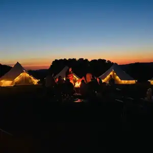 Guests around firepit at sunset